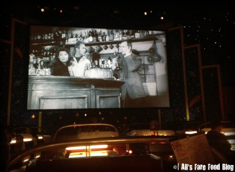 The large movie screen at Sci-Fi Dine-in Theater plays B-movie clips