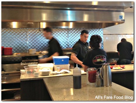 View of the kitchen from the counter at Red's Kitchen and Tavern